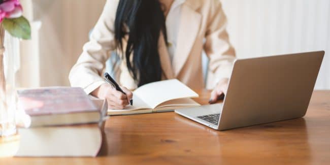 woman-writing-on-notebook-3803242